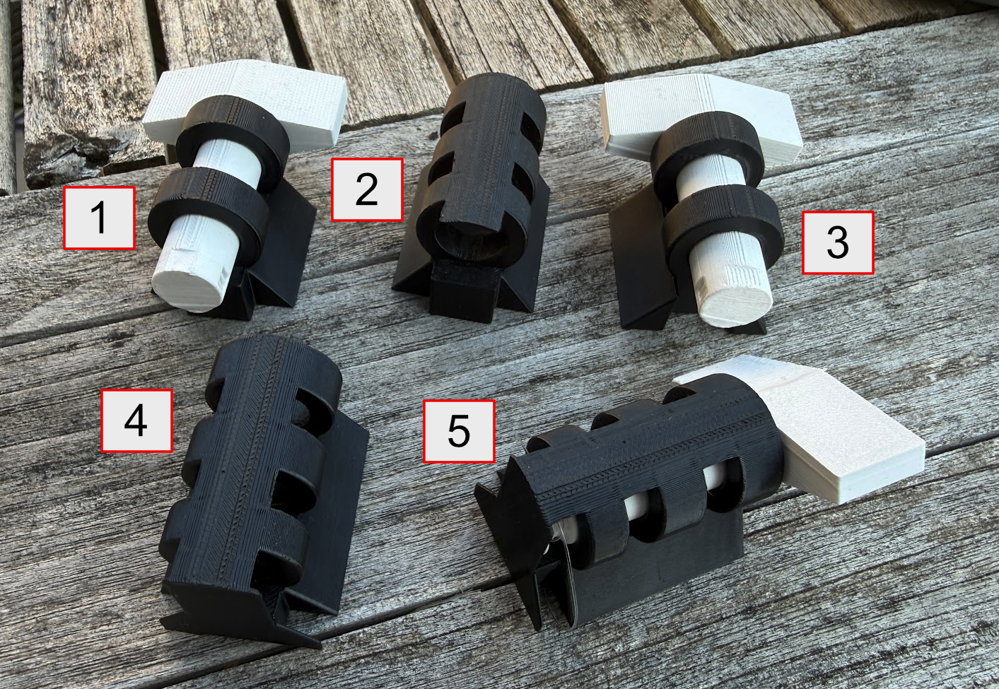 Image of five 3D prints showing four failed prototypes and the final model